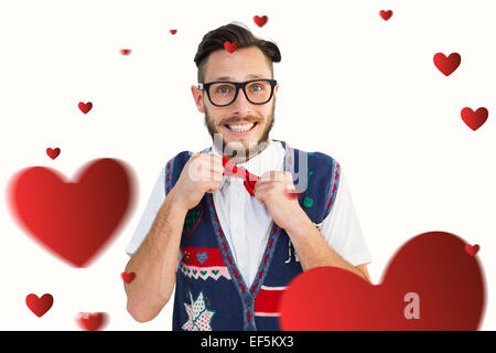 Composite image of geeky hipster wearing christmas vest Stock Photo