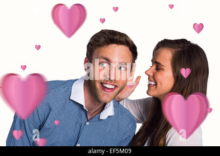 Composite image of happy young woman whispering secret into friends ear Stock Photo