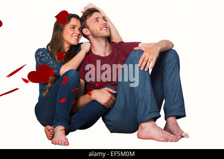 Composite image of young couple sitting on floor Stock Photo