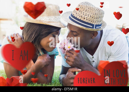 Composite image of cute valentines couple Stock Photo