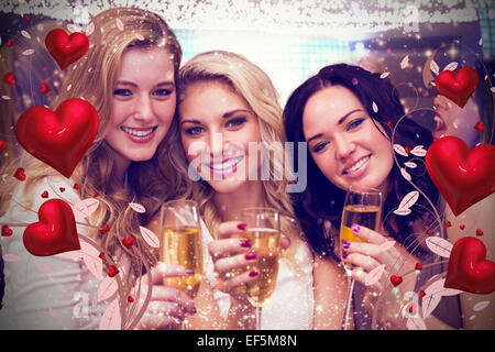 Composite image of pretty friends drinking champagne together Stock Photo