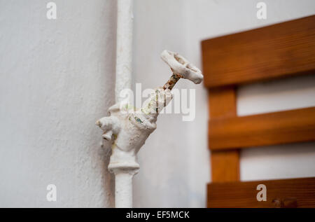 Hot water turncock covered with paint Stock Photo