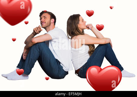 Composite image of young couple sitting on floor Stock Photo