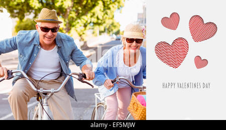 Composite image of happy mature couple going for a bike ride in the city Stock Photo