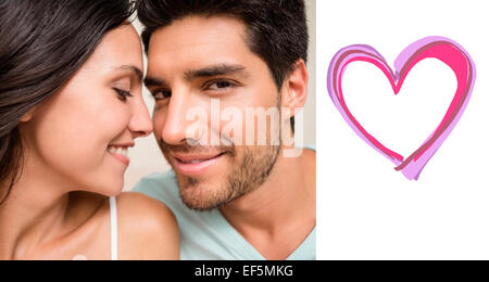 Composite image of attractive couple sitting on bed Stock Photo