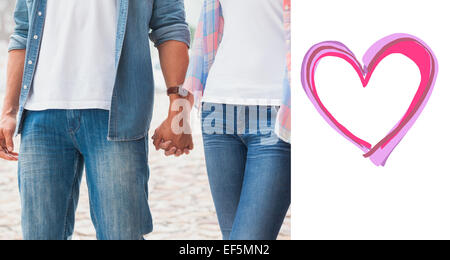 Composite image of hip young couple holding hands Stock Photo