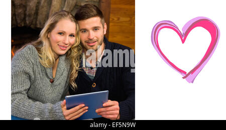 Composite image of lovely couple using tablet pc at Stock Photo