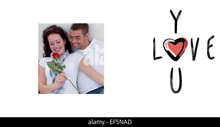 Composite image of couple on sofa with a rose Stock Photo