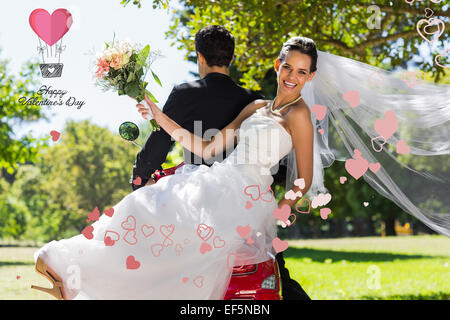 Composite image of newlywed couple sitting on scooter in park Stock Photo