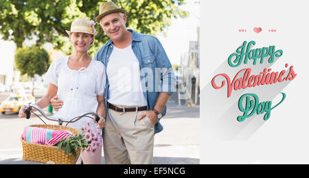 Composite image of happy mature couple going for a bike ride in the city Stock Photo