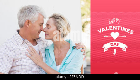 Composite image of happy mature couple sitting on bench in the city Stock Photo