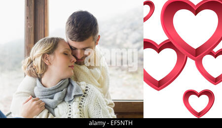 Composite image of close up of a loving young couple in winter clothing Stock Photo