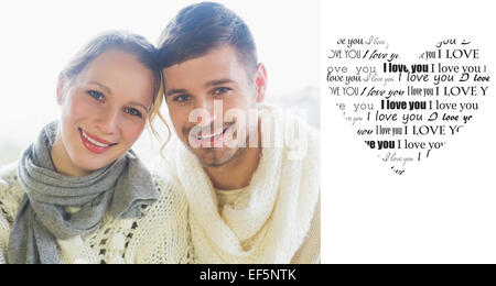Composite image of close up portrait of a loving couple in winter clothing Stock Photo