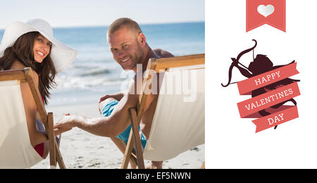 Composite image of cute couple looking while lying on their deck chairs Stock Photo