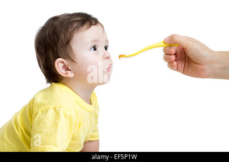 baby eating food isolated on white Stock Photo