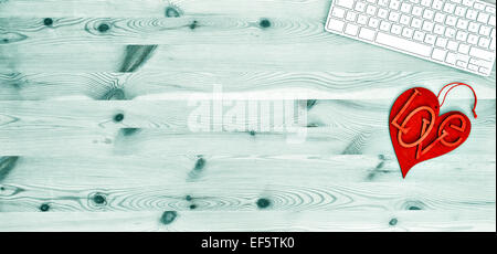 Keyboard and red LOVE heart on wooden office table background Stock Photo