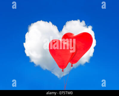 Two red balloons and heart shaped cloud in the perfect blue sky. Valentines Day Stock Photo