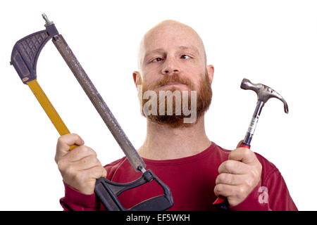 silly man holding hammer and saw in his hands Stock Photo