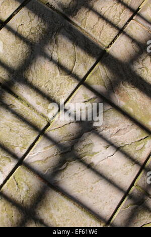 Stone slabs with lines of rectangular shadows Stock Photo