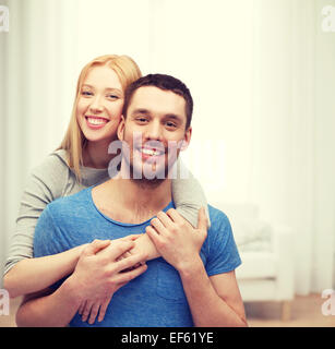 Cute couple hugging and smiling in their new home. Moving to new apparment.  Stock Photo