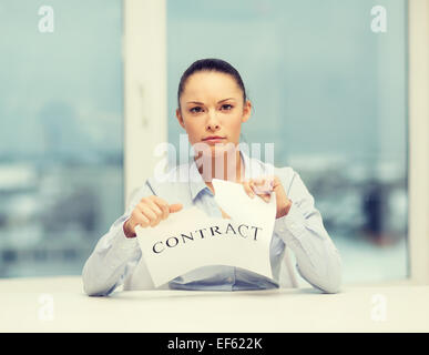 serious businesswoman tearing contract Stock Photo