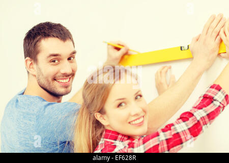 couple building using spirit level to measure Stock Photo