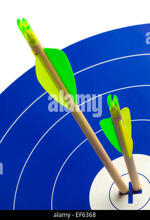 Two Wood Arrows in Center of Blue and White Target. Stock Photo