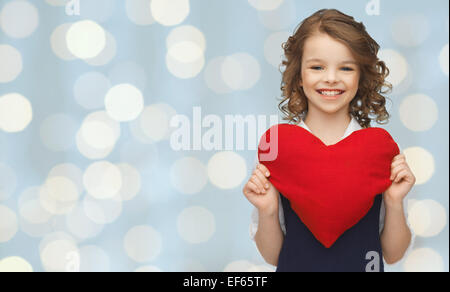 smiling little girl with red heart