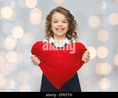 smiling little girl with red heart