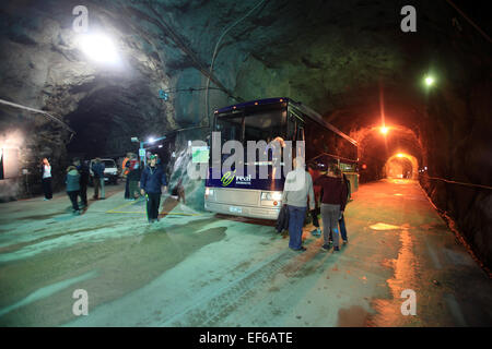 Road into Manapouri Power Station with tourist bus stopped to load passengers, Fiordland, New Zealand Stock Photo