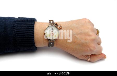 A woman's arm wearing a wrist watch on a white background Stock Photo