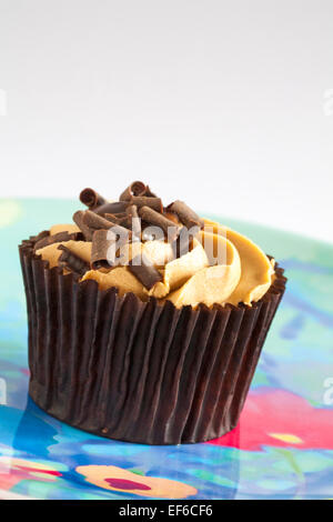 Tesco salted caramel cupcakes - caramel flavoured sponge with salted caramel sauce and rich caramel frosting set on plate Stock Photo