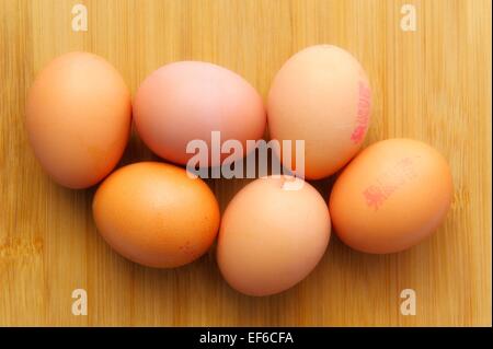 6 brown eggs on a wooden background Stock Photo