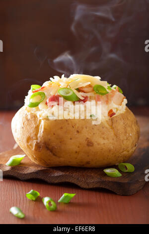 baked potato in jacket with bacon and cheese Stock Photo