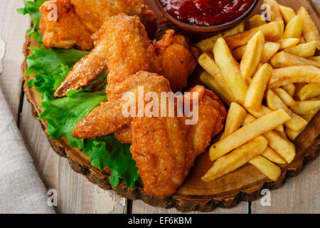 Fried chicken wings with sauce and French fries Stock Photo