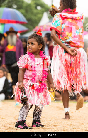 A child in traditional dress with Torres Strait Islander women dancers performing at the Yabun Festival on Australia Day 2015. Stock Photo
