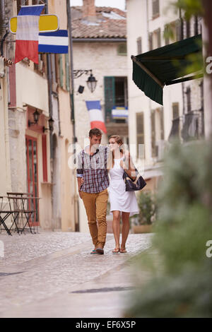 Young Couple on holiday walking in the town of La Colle Sur Loup in the south of France . Stock Photo