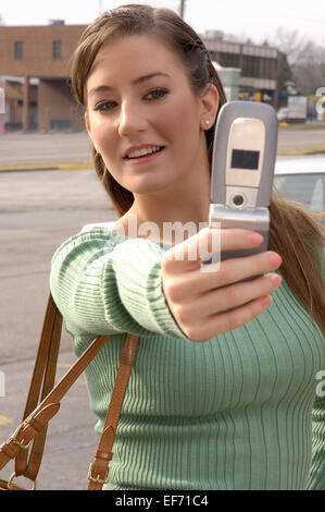 Young woman taking a selfie on a city street. Stock Photo