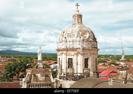 Dome of the church Iglesia de la Merced above the red roofs of Granada, Granada province, Nicaragua Stock Photo