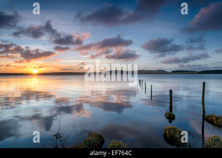 A beautiful sunrise over Crowdy Reservoir a large lake on Bodmin Moor near Davidstow in Cornwall Stock Photo