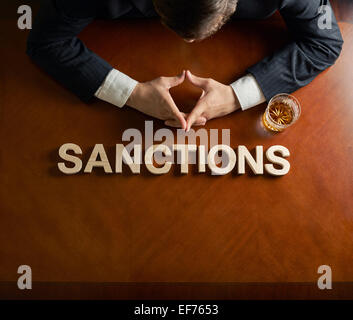 Word Sanctions made of wooden block letters with dramatic lighting