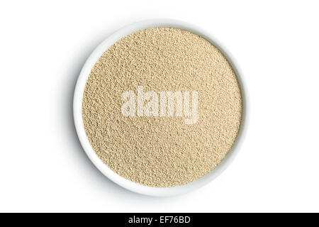 dry yeast in bowl on white background Stock Photo