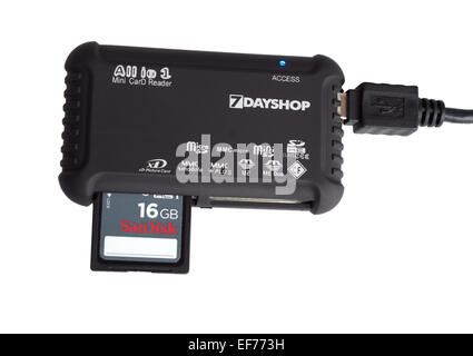 A multipurpose mini card reader by 7dayshop, with an attached 16GB SanDisk memory card, isolated on a white background. Stock Photo
