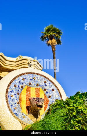 Mosaic dragon's head water fountain. Park Guell designed by Antoni Gaudi architect. Barcelona, Catalonia, Spain. Stock Photo