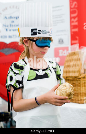 Girl in blindfold trying to guess which vegetable she was holding.  Children's Food Festival Abingdon 2007 - Earth Trust Stock Photo