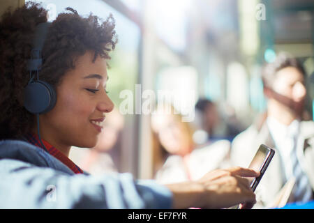 Woman using digital tablet on train Stock Photo