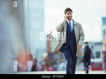 Businessman talking on cell phone outdoors Stock Photo