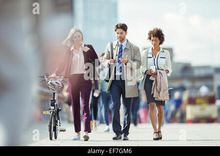 Business people walking and talking in city Stock Photo