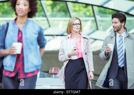 Business people talking in train station Stock Photo