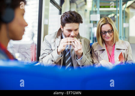 Business people eating on train Stock Photo